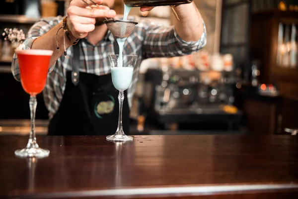 Bartender making white cocktail at bar counter — 스톡 사진