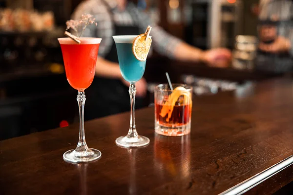 Different multi-colored drinks on counter in bar — 스톡 사진