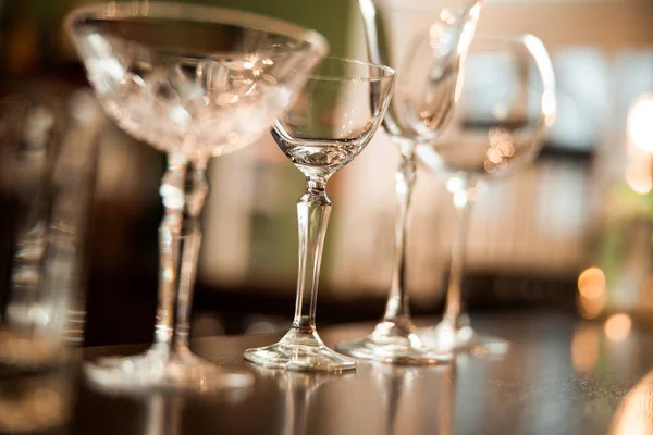 Empty clean glasses on counter in bar Royalty Free Stock Photos