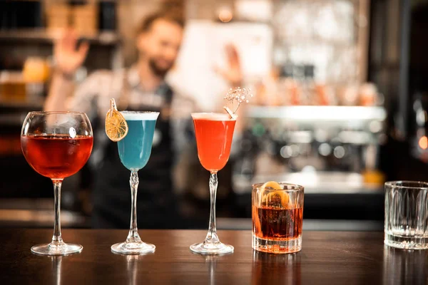 Beautiful row line of different colored alcohol cocktails — 스톡 사진