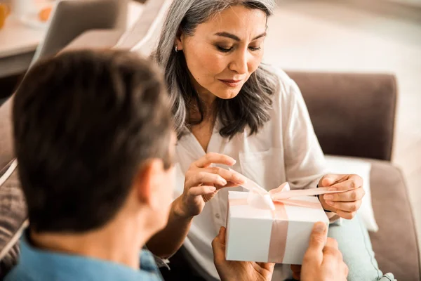 Pretty adult lady holding tape on the box at home — Stock Photo, Image