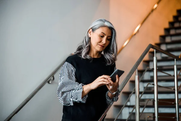 Calm lady on the stairs with her gadget stock photo — Stock Photo, Image