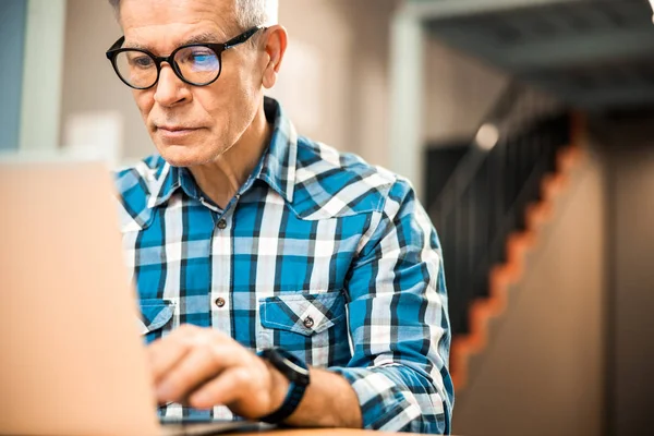 Mature male working with laptop at workplace — Stock Photo, Image