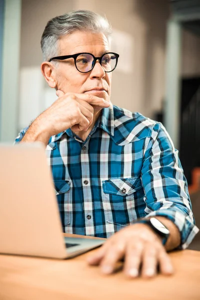 Adult man in glasses looking away indoors — Stock Photo, Image