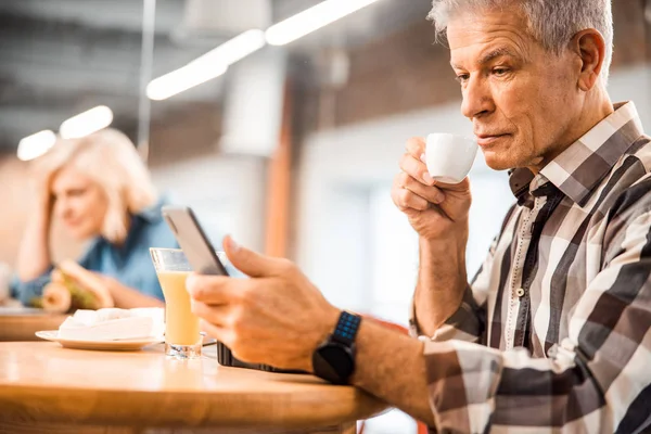 Stylish adult man drinking coffee in cafe — Stock Photo, Image