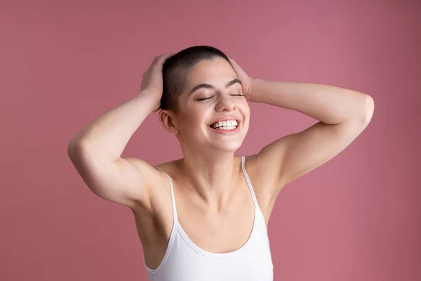 Delighted young girl feeling good and smiling stock photo — 图库照片