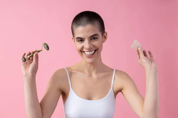 Excited lady showing her Gua Sha tools stock photo — Stockfoto