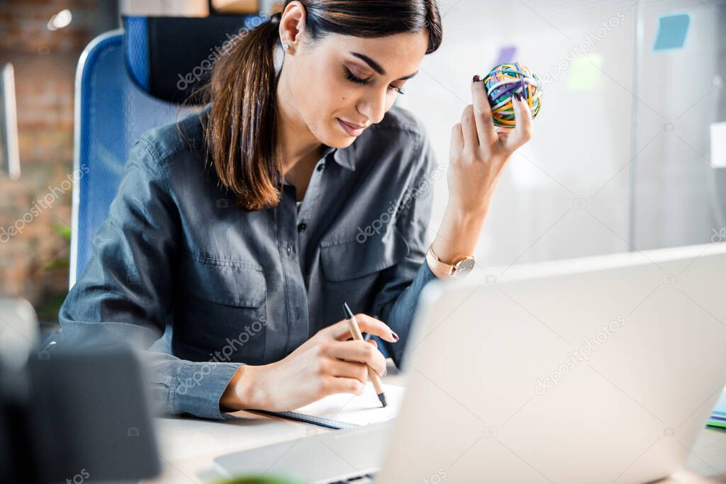 Concentrated office worker reading her plans for the day