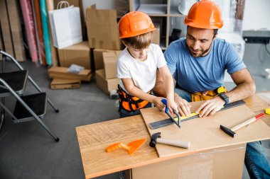 Happy parent teacing kid of plumber work stock photo