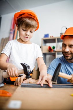 Smiling parent and kid using hand tools stock photo