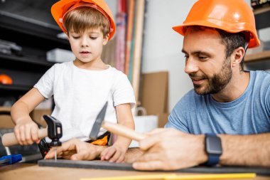 Happy carpenter is teaching son stock photo