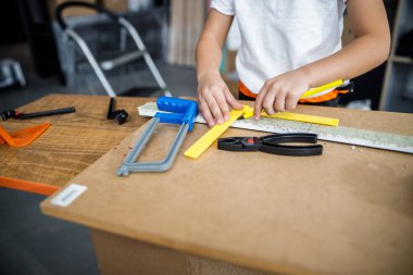 Kid making measurements on desk stock photo