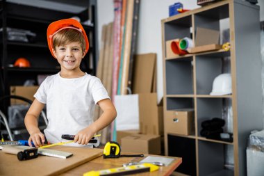 Cheerful boy tindering from desk stock photo