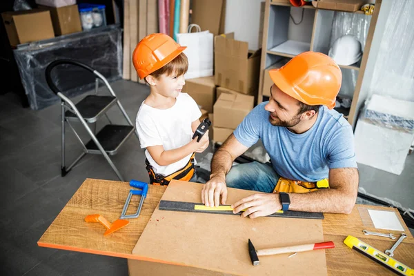 Cheerful family using tools in workshop stock photo — 图库照片