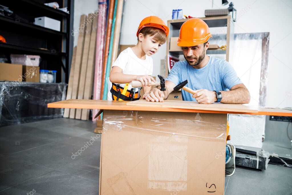 Father with son together in workshop stock photo