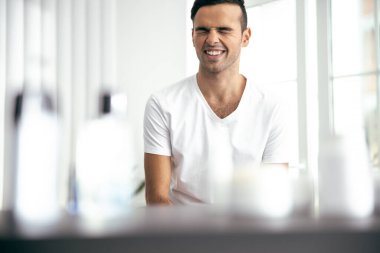 Young man having fun in his flat