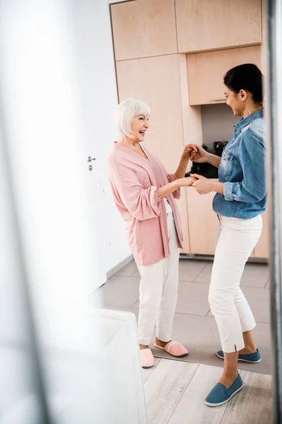 Grandmother and adult granddaughter having fun at home — Stock Photo, Image