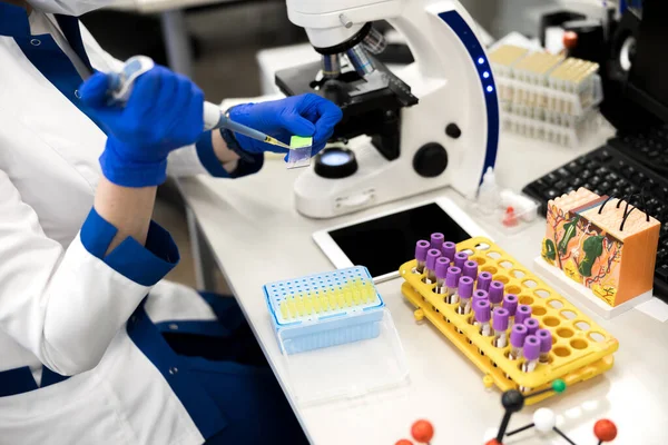 Young female scientist using laboratory sampler during research — Stock Photo, Image