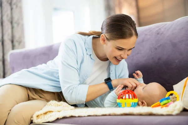 Happy young mother and child boy playing together indoors at home — Stock Photo, Image