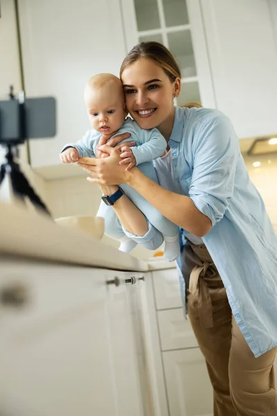 Happy pretty woman and her baby having fun — Stock Photo, Image