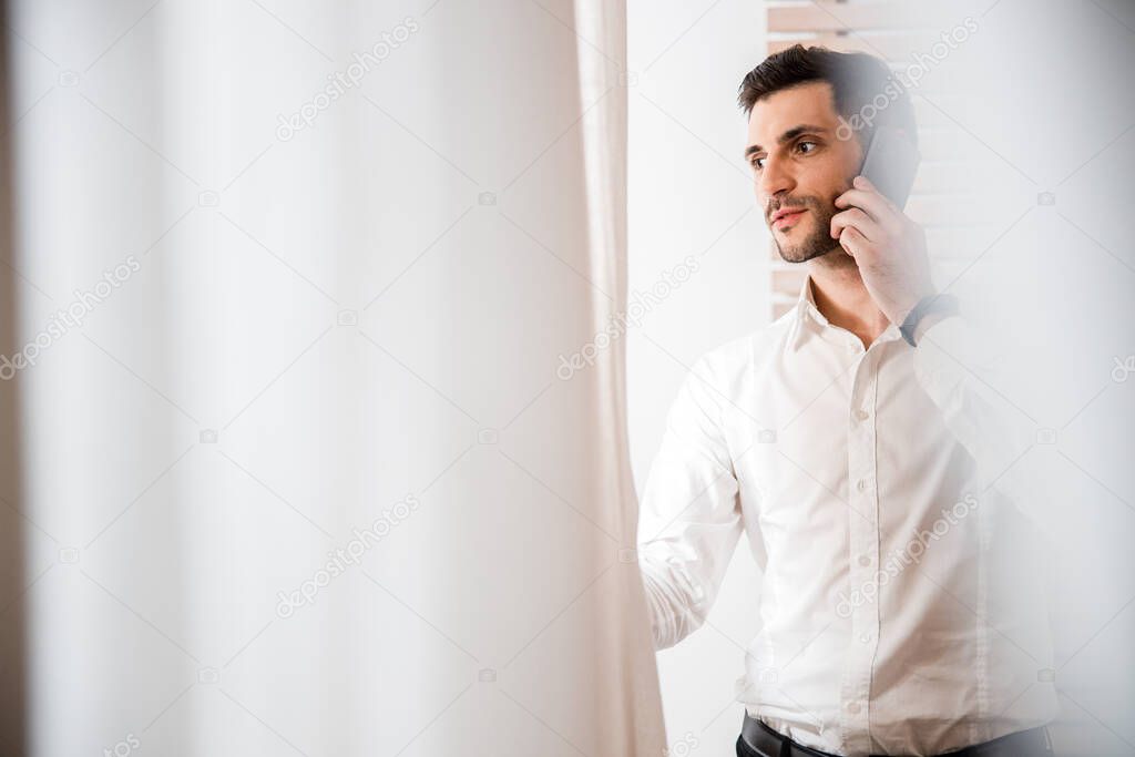 Young man talking on phone indoors stock photo
