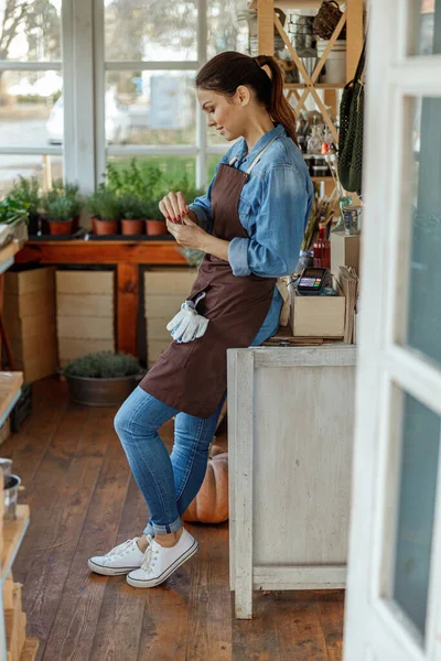 Plaisant botaniste debout dans un magasin de fleurs — Photo