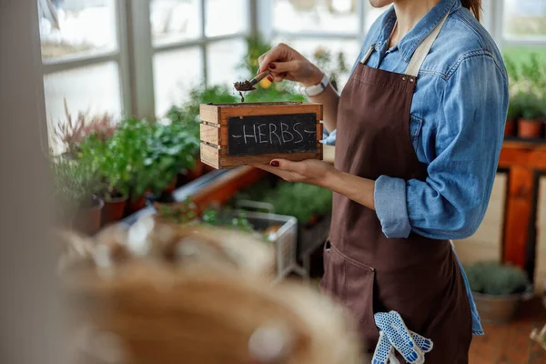 Woman holding a wooden box with one hand — Stock Photo, Image