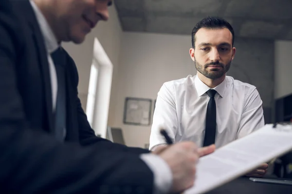 Jonge kantoormedewerker wacht op resultaten in het kantoor — Stockfoto