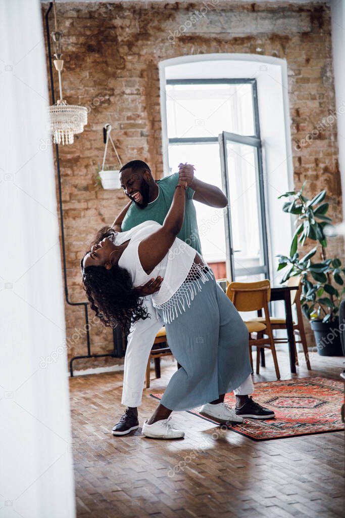 Beautiful couple looking excited while dancing stock photo