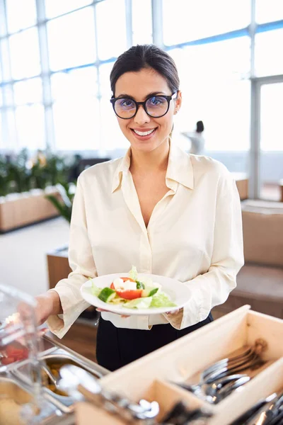 Beautiful lady holding plate with fresh vegetable salad — Stock Photo, Image