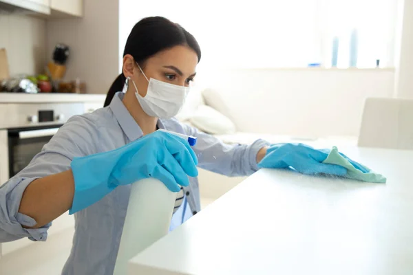 Young woman cleaning house with sanitizer spray — Stock Photo, Image