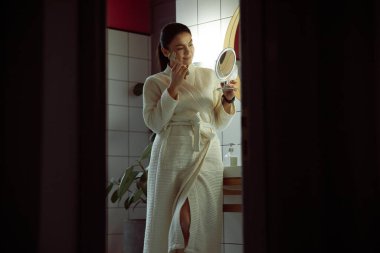 Gülümseyen kadın, stok fotoğraflarında güzellik prosedürleri uyguluyor.