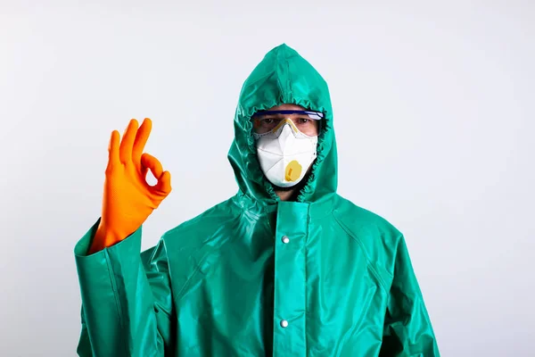 Gesture OK being demonstrated by disinfectant worker stock photo — Stock Photo, Image
