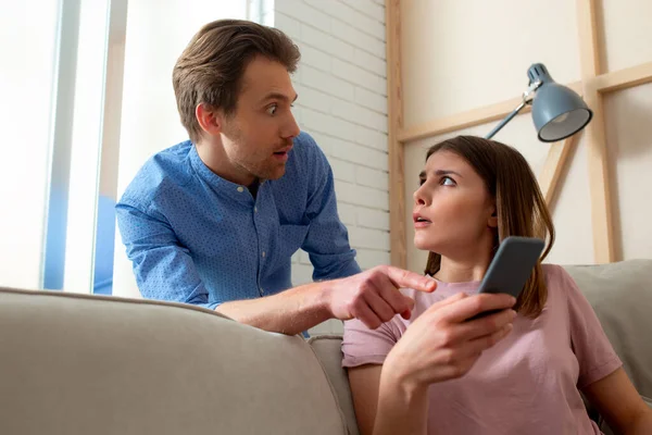 Mulher chocada está assistindo vídeo no smartphone — Fotografia de Stock