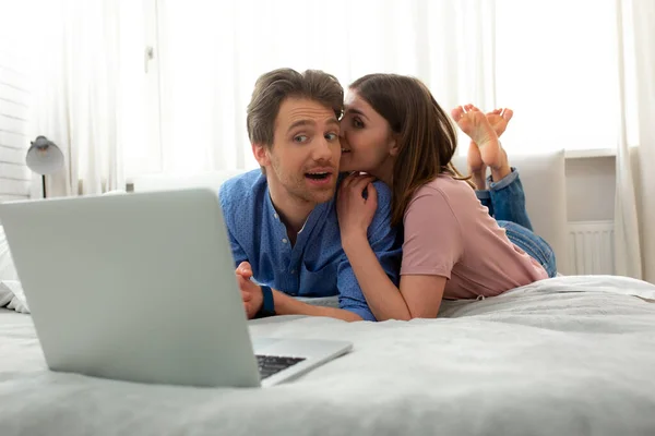 Man and woman are lying on bed at home — Stock Photo, Image