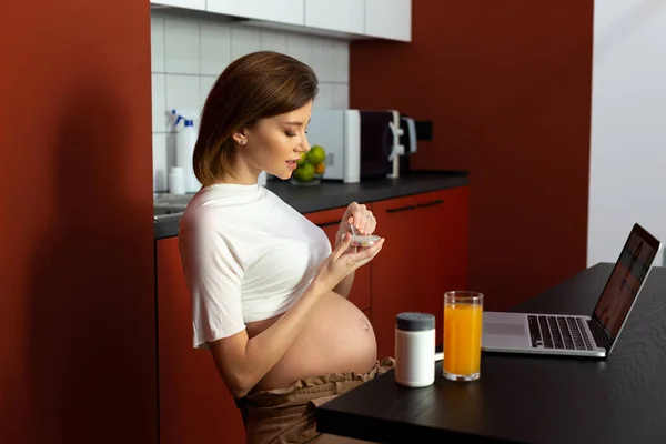 Cuidado mulher grávida caixa de pílula de abertura em casa — Fotografia de Stock