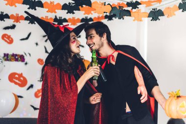 Balkabağı tutan ve karnaval kıyafeti giyen çift. 