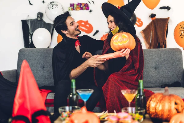 Couple having fun holding pumpkins and wearing dressed carnival — Stock Photo, Image