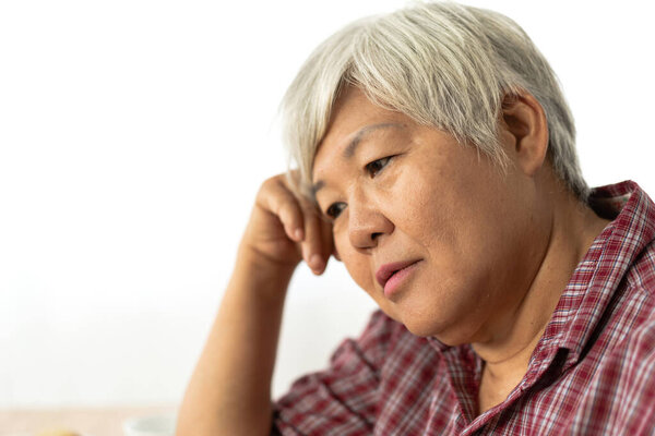 Senior adult elderly asia women serious depressed and feeling he