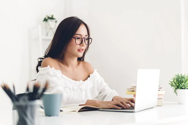 Chica estudiante sentada y estudiando y aprendiendo en línea con lapto — Foto de Stock