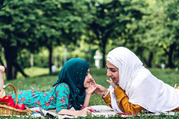 Portrait of happy muslim mother and little muslim girls child le