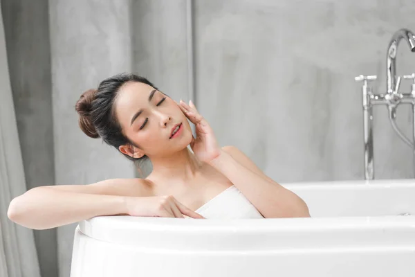 Belle jeune femme asiatique profiter de détente prendre un bain avec bourgeon — Photo