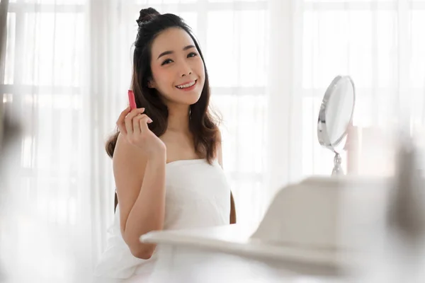 Smiling beautiful woman fresh healthy skin looking on mirror and