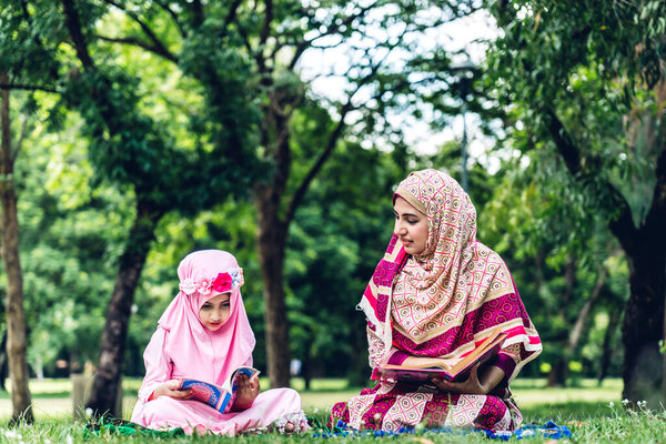 Portrait of happy muslim mother and little muslim girls child  w