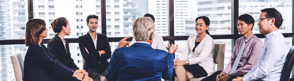 Businessman in front of group of people in consulting meeting co