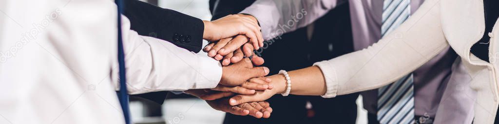 Successful of group business people stack and putting their hand