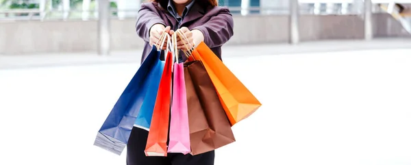 Mulher segurando saco de compras andando na rua — Fotografia de Stock