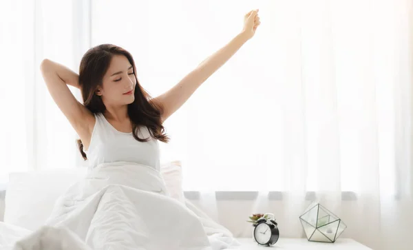 Woman stretching happy and relaxed after wake up in the morning — Stock Photo, Image