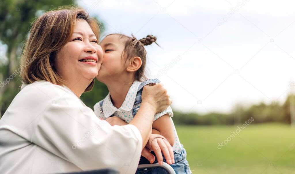 Portrait of happy grandmother and little cute girl enjoy relax together in summer park.Family and togetherness
