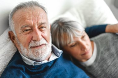 Üst düzey mutlu çift evde yatak odasında uzanıp konuşuyor. Yaşlı karı koca Camara 'ya bakıyor. Emeklilik çifti kavramı.
